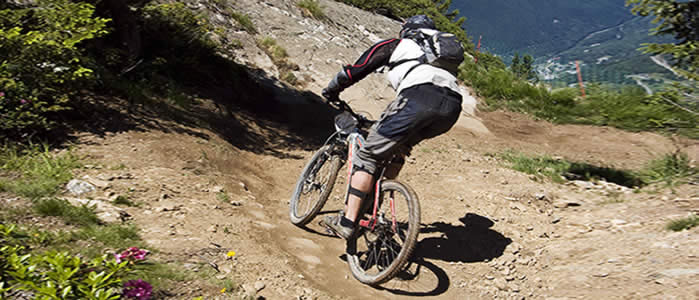 A rider descends an alpine trail